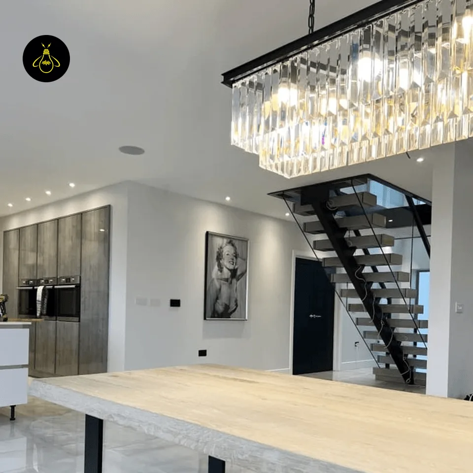 Rectangular Crystal Chandelier – Satin Gold 2-Tier Eternal Shine 9 Rectangular crystal chandelier lighting a modern dining room in satin gold