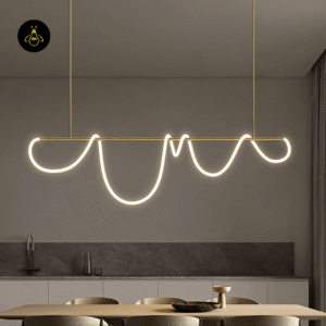 Linear LED chandelier glowing warm above a contemporary kitchen island