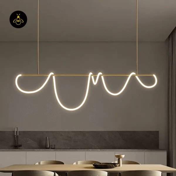 Linear LED chandelier glowing warm above a contemporary kitchen island