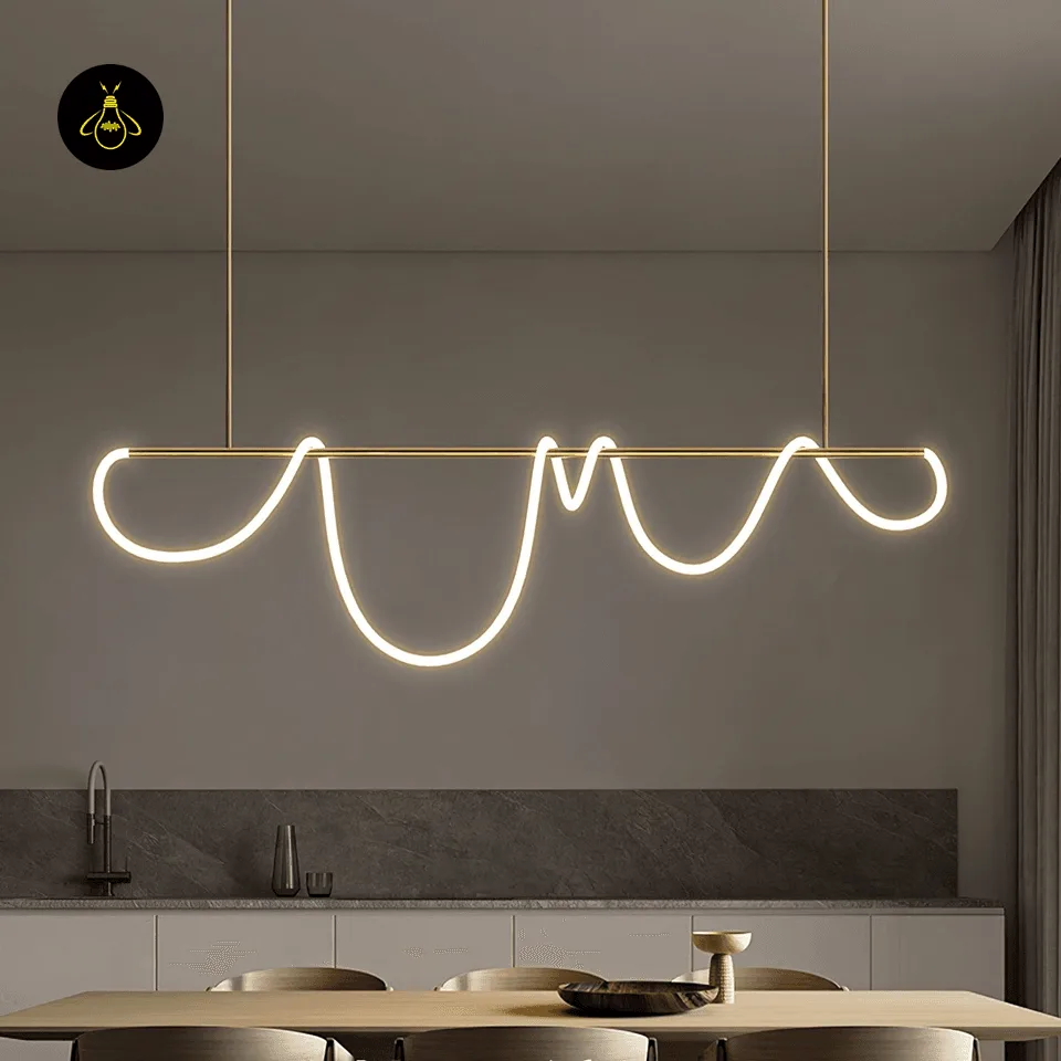 Linear LED Chandelier – 150 cm Gold Silicone Ribbon Light, Adjustable Height 7 Linear LED chandelier glowing warm above a contemporary kitchen island