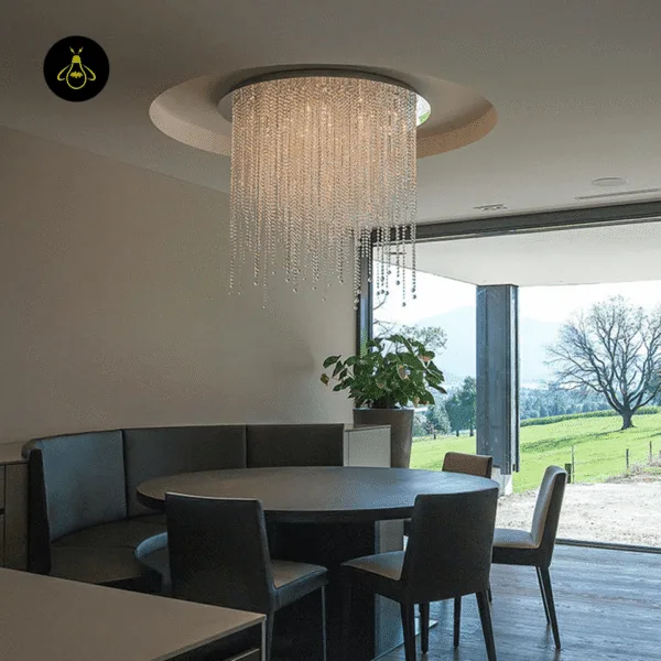 Round crystal chandelier for a dining room above a modern dining table