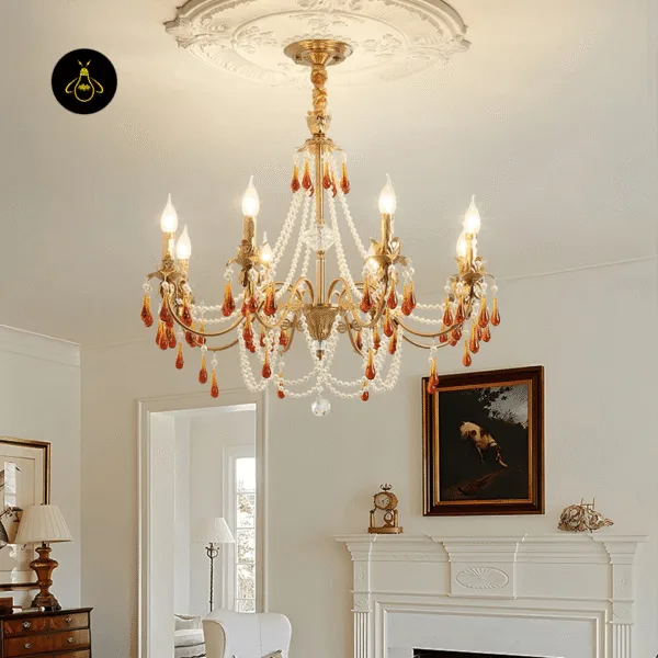 Amber crystal chandelier with flame-tip candle bulbs over a classic living room