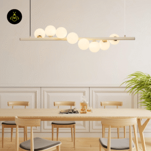 Linear glass ball chandelier glowing warm over a wooden dining table