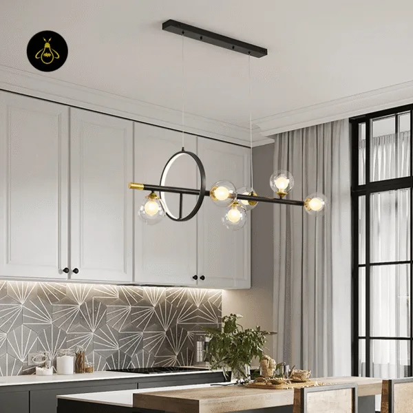 Six globe glass and brass dining table chandelier with warm G9 bulbs over a kitchen dining island