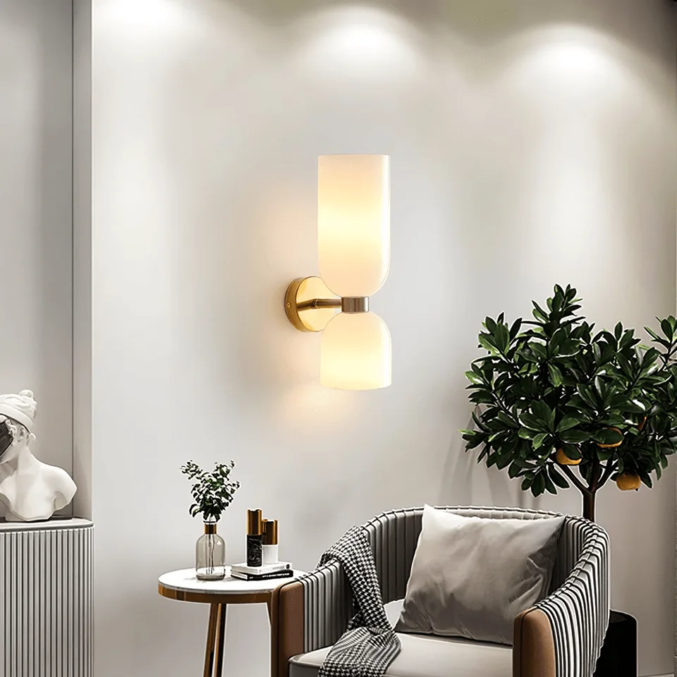 Up Down Wall Light – Opal Glass Wall Sconce, Satin Brass Finish, 35 cm 7 Wall sconce for bedroom or living room glowing up and down above a striped armchair and side table