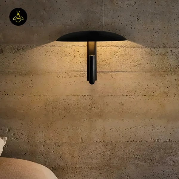 Wall light with reading light casting warm light down a textured concrete wall, reading spot turned up