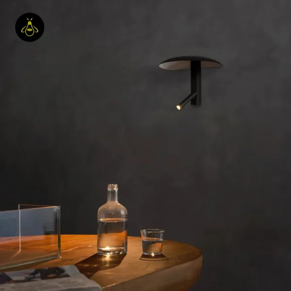 Wall light with reading light on a dark grey wall, reading spot tilted down over a wooden table