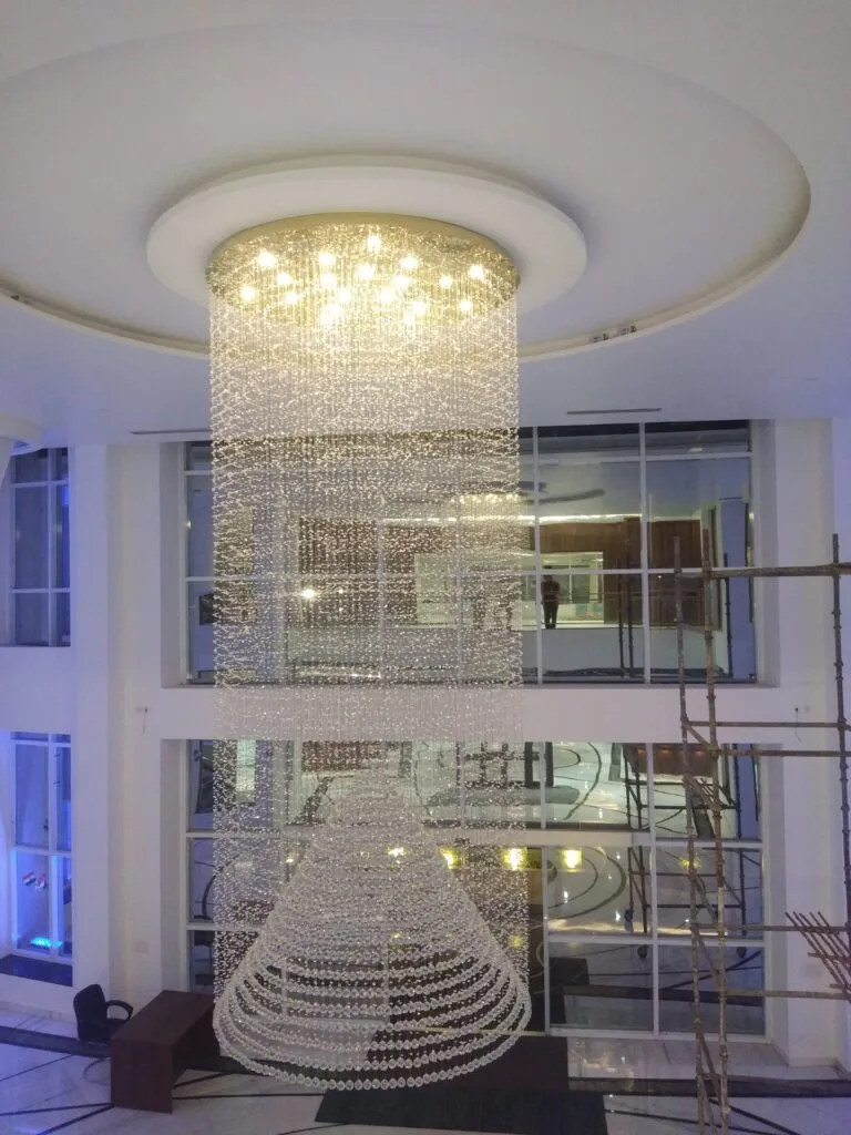 Clubhouse chandelier Noida - 18-foot crystal showpiece at Purvanchal Royal City clubhouse lobby