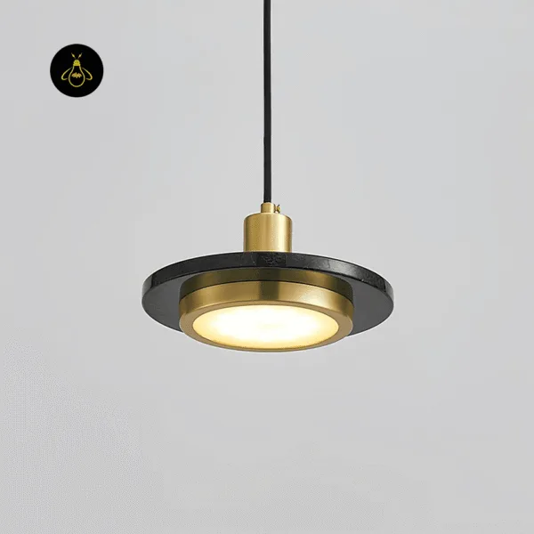 Black marble pendant light switched on, warm 3000K glow through the white diffuser in the gold drum