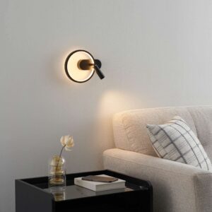 Black circle wall light mounted beside a sofa for reading