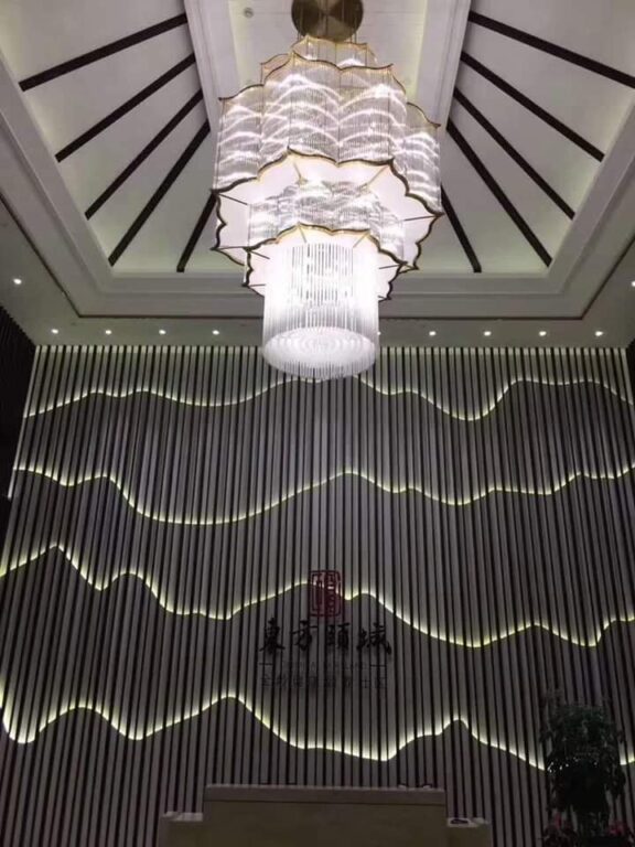 Tall lotus-inspired crystal chandelier installed in the lobby at Silver Oak Hotel and Banquet Kanyakumari