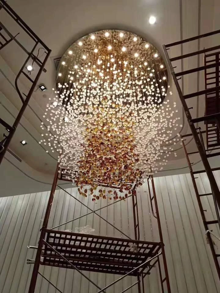 Warm-toned suspended stone chandelier beneath a circular ceiling canopy in Kerala