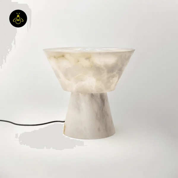 Alabaster mushroom table lamp, unlit, with its black cord on a white background