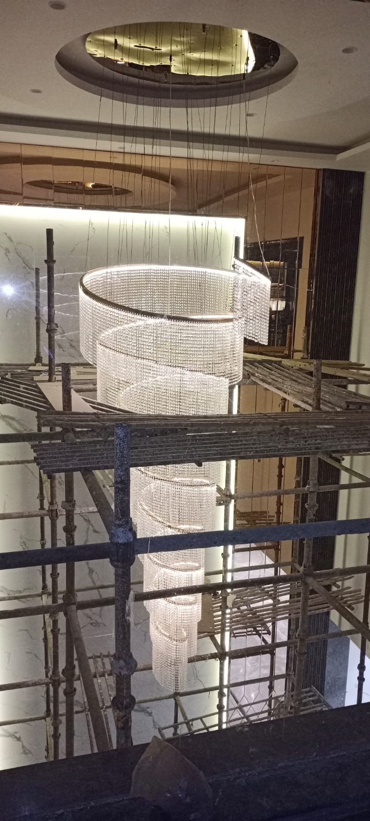 Modern residential chandelier installation at SKA Divya Towers