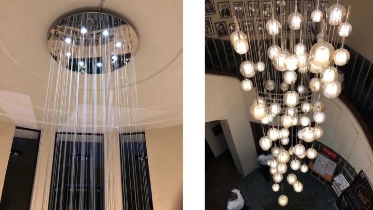Wide atrium view of the DPS Siliguri chandelier with suspended glowing globes