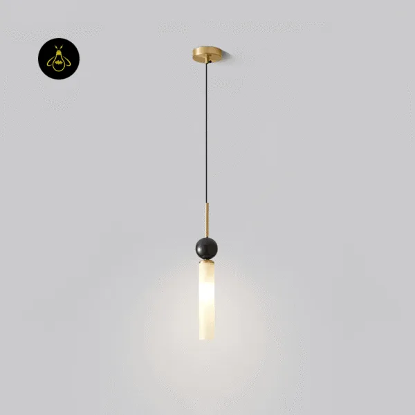 Single marble pendant light lit, white marble cylinder and black marble sphere on a brass-finish stem and small round canopy