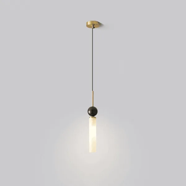 Single marble pendant light lit, white marble cylinder and black marble sphere on a brass-finish stem and small round canopy
