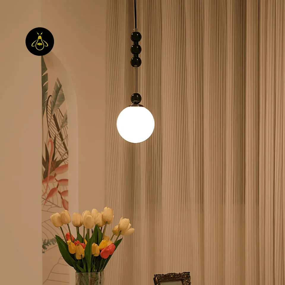 Glass Globe Pendant Light – Bola 15 cm Opal Bedside Pendant, E27 2 Opal glass globe pendant light glowing warm over a console in a modern living room