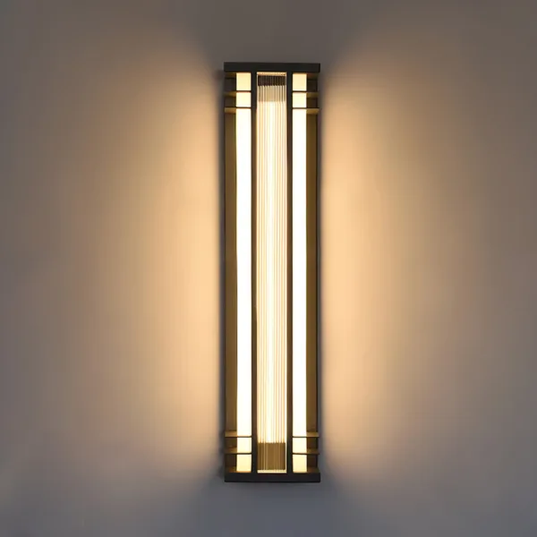 Outdoor wall sconce lit on a grey wall, warm 3000K light washing the wall on both sides