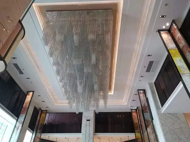 Close-up of the linear sculptural chandelier at Chateau Royale Hotel and Banquet Nagpur