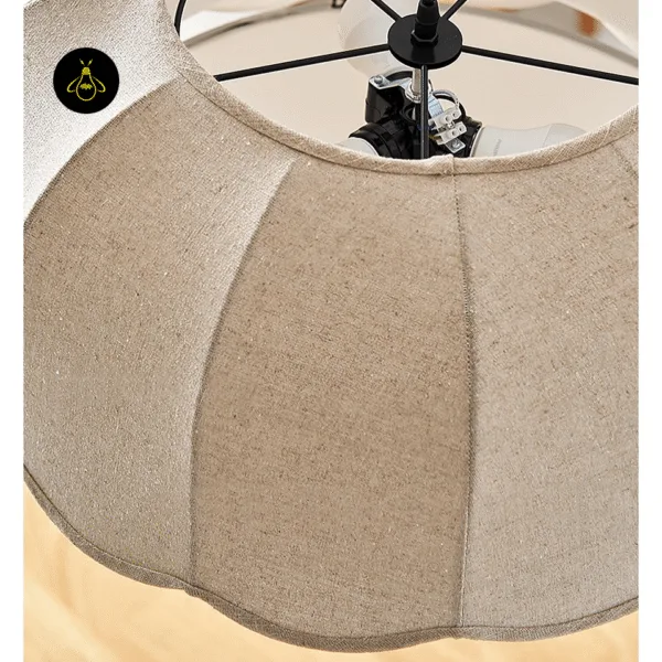 Top of the fabric pendant light showing the black stainless steel holder and socket above the beige shade