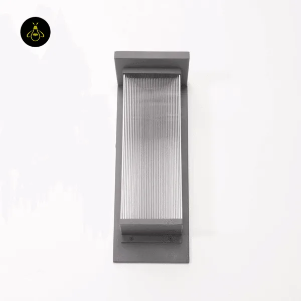 Front view of the entrance light unlit: charcoal grey stainless steel frame and ribbed clear acrylic diffuser