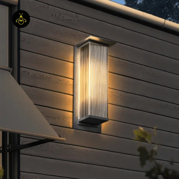 Entrance light on a horizontal wood-clad house wall near an awning at dusk