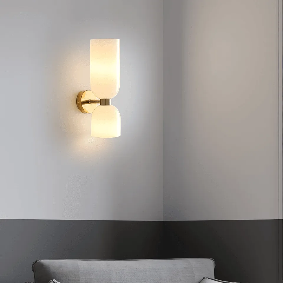 Up Down Wall Light – Opal Glass Wall Sconce, Satin Brass Finish, 35 cm 9 Opal glass wall sconce for bedroom casting warm up and down light on a grey wall above a sofa