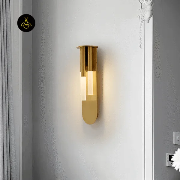 Glass wall lamp lit on a white panelled wall beside grey curtains