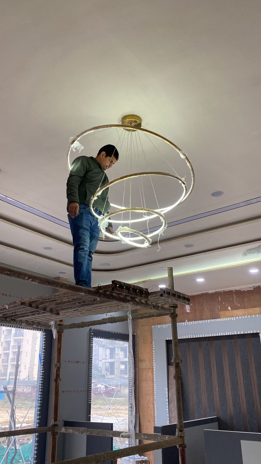 Double Height LED Chandelier: 5 Bold Ideas From SKA Destiny One 2 Double height LED chandelier with four gold rings being installed at the SKA Destiny One project