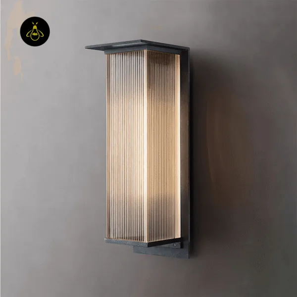 Lit entrance light on a grey plaster wall, angled to show the ribbed diffuser, flat canopy and slim backplate