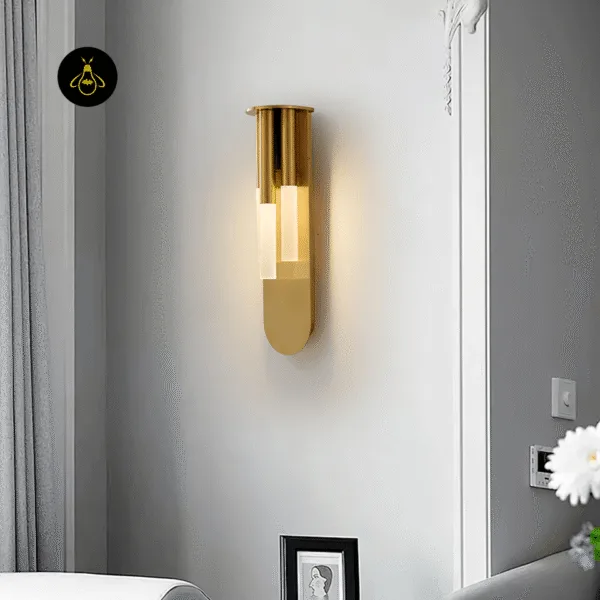 Angled view of the 43 cm glass wall lamp on a living room wall above a sofa and framed picture