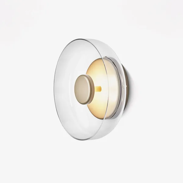 Circular wall light Solara switched off: clear borosilicate glass dish over a brass-finish stainless steel disc, side view