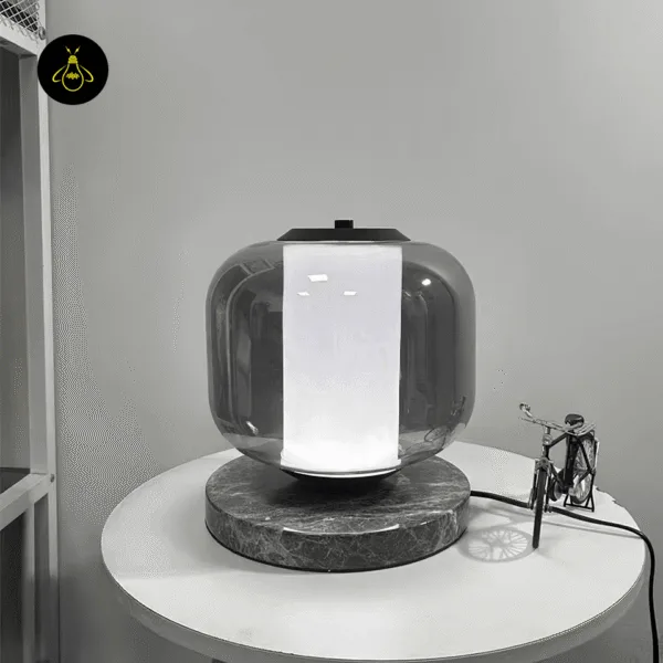 Smoked borosilicate glass shade detail on the black marble table lamp