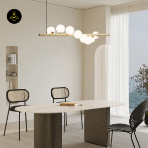 Linear glass ball chandelier casting a soft warm glow over a dining table