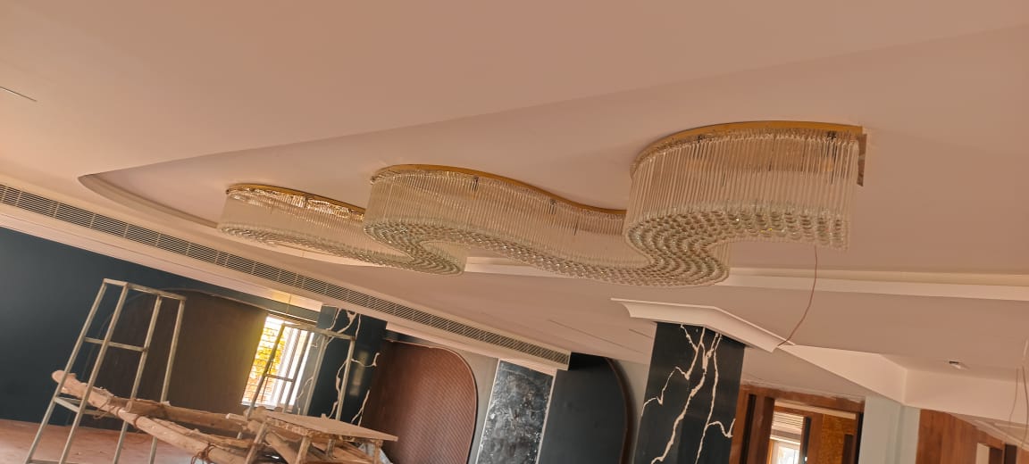 Solid clear crystal rods arranged around the custom banquet chandelier