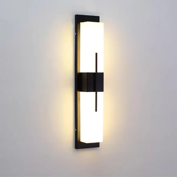 Alabaster outdoor wall light glowing warm on a grey wall, matte black stainless steel backplate and centre band