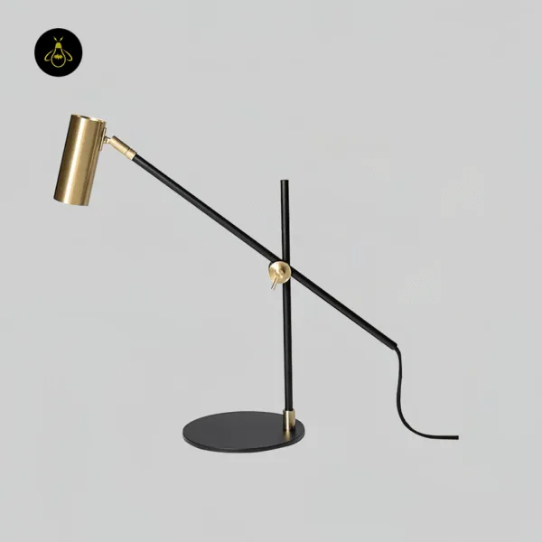 Modern brass desk lamp with black balance arm for study and work interiors