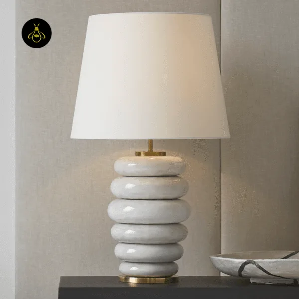 Stacked ceramic table lamp styled on a console with linen shade for interior decor