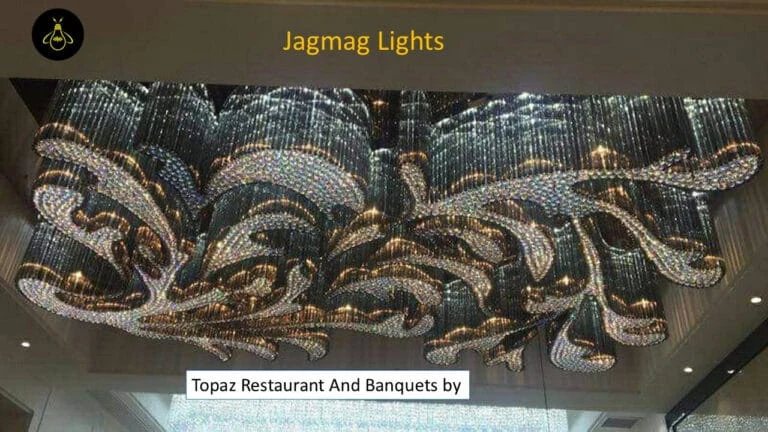Close view of the smoky and clear crystal chandelier installed at Topaz Radiance Surat