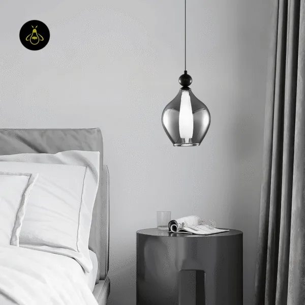 Wide black smoked glass pendant light hanging over a round bedside table
