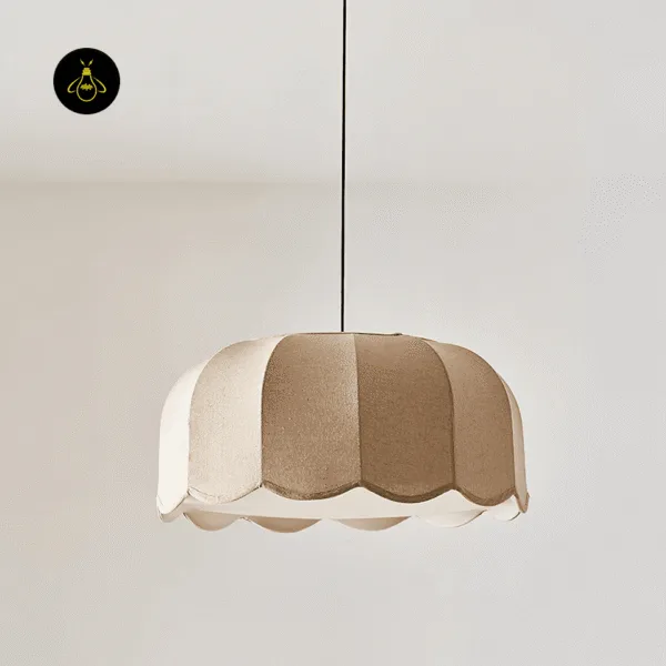 Scalloped beige fabric pendant light switched off, showing the panel seams and white edge
