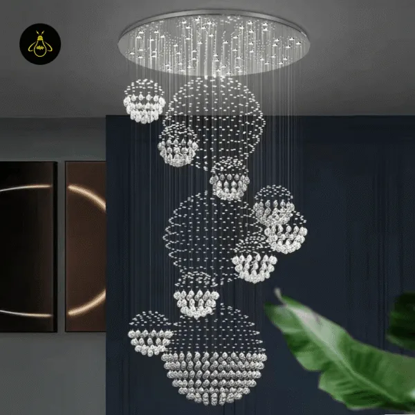 Spiral raindrop crystal chandelier installed in a double-height staircase