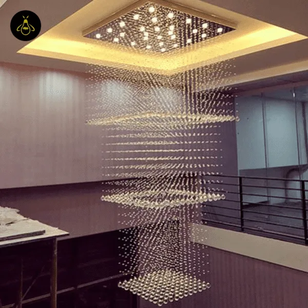 Multi-tier K9 crystal raindrop chandelier in a double-height staircase void