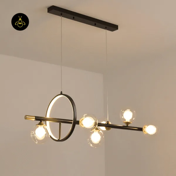 Linear glass globe dining table chandelier lit with warm white bulbs and a glowing LED ring