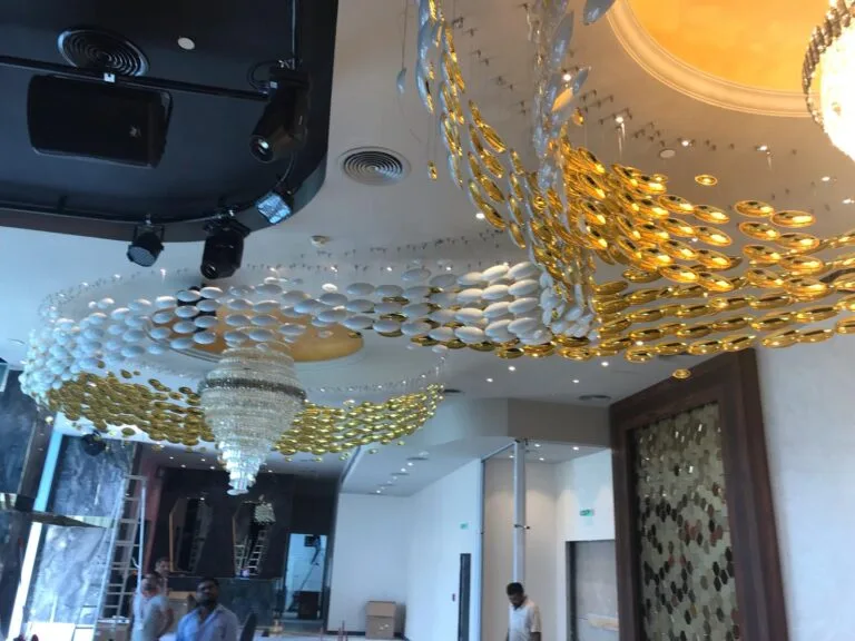 Decorative restaurant ceiling detail with white and gold layered shell forms
