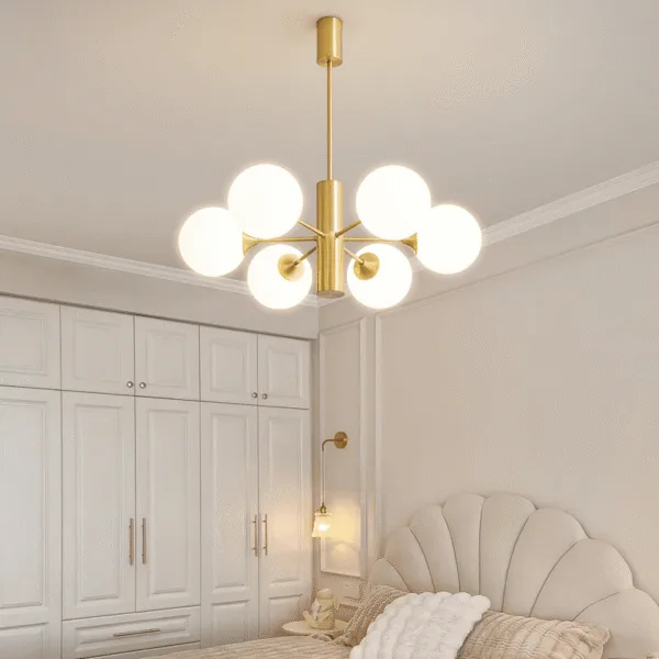 Modern brass chandelier viewed from below showing the ceiling canopy in a bedroom
