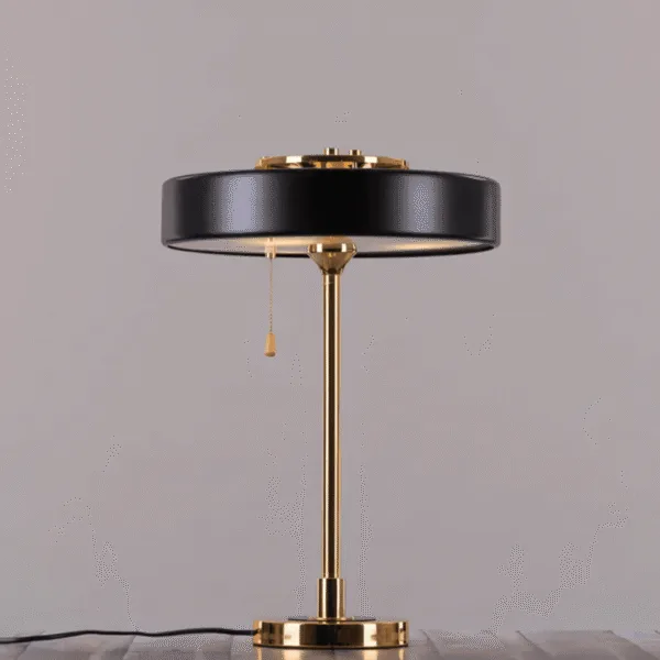 Black and gold retro study lamp on a bedside table in a cozy bedroom
