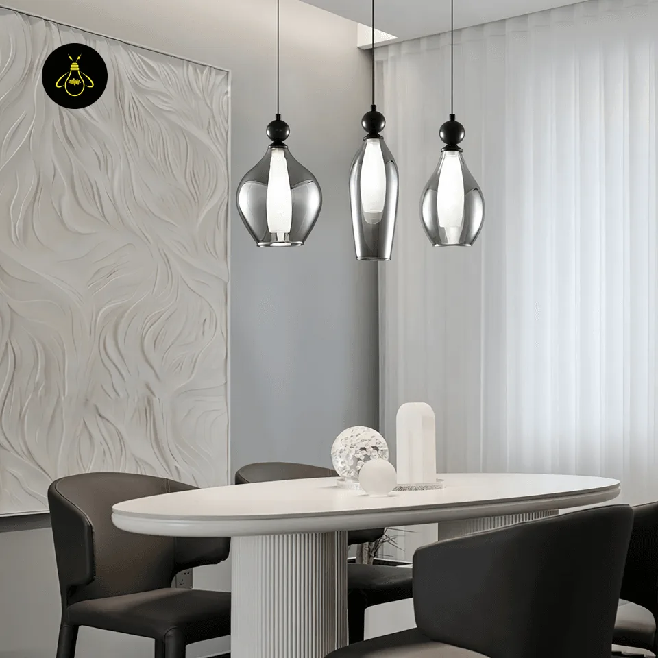 Black smoked glass pendant lights over an oval dining table