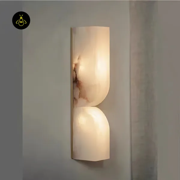 Alabaster wall light switched on, warm 3000K glow through the veined stone, up and down